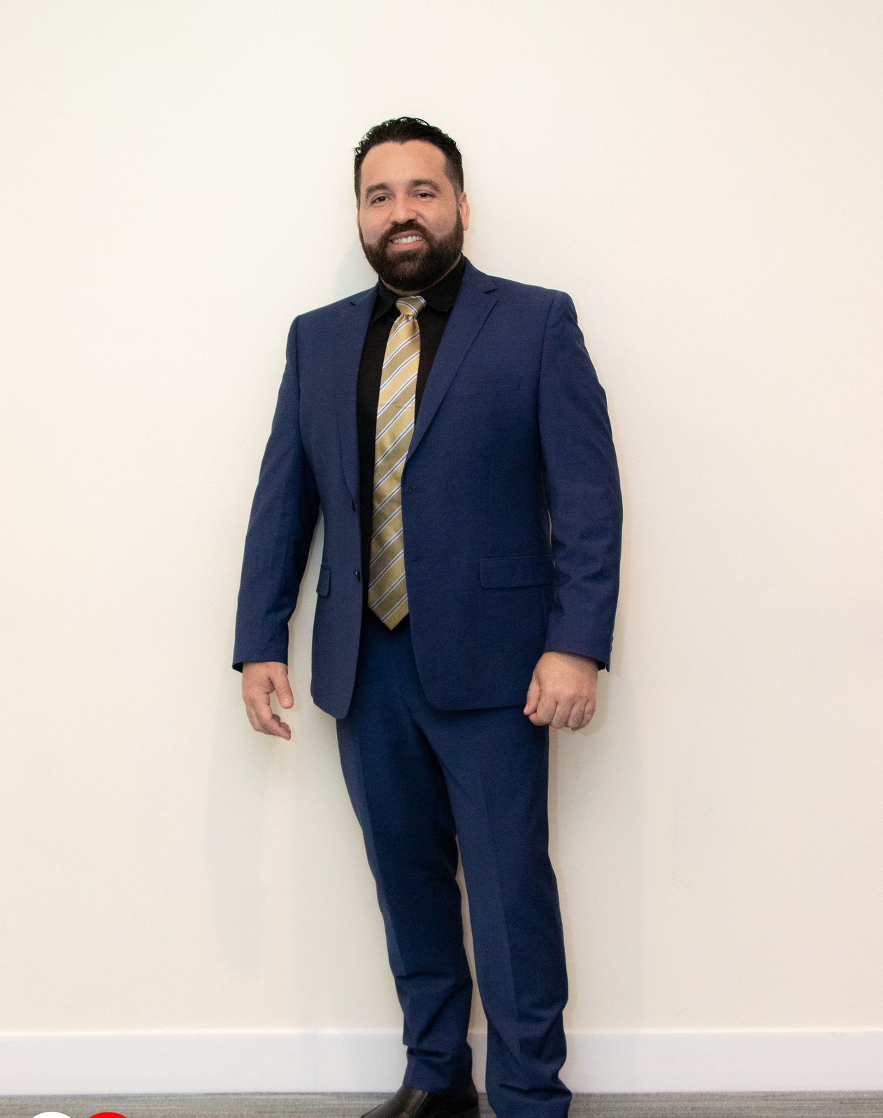 Carlos Leras standing in a navy suit
