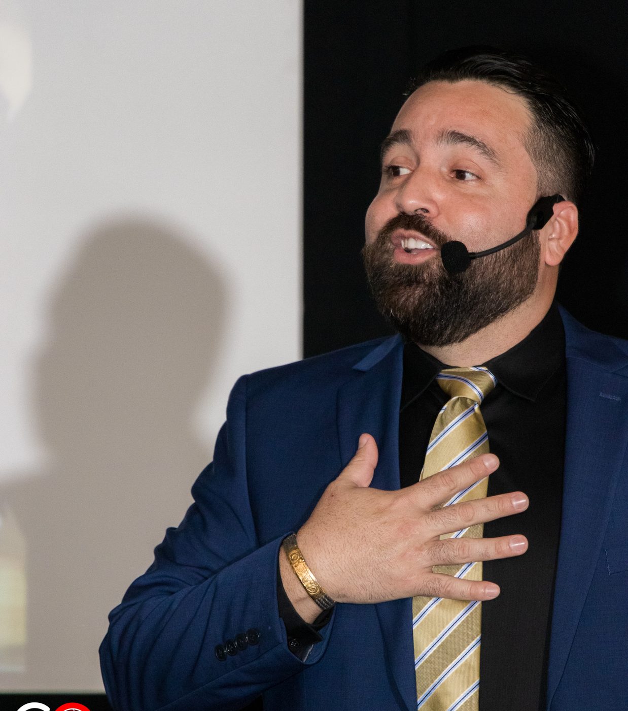 Close-up of Carlos Leras speaking with a headset microphone