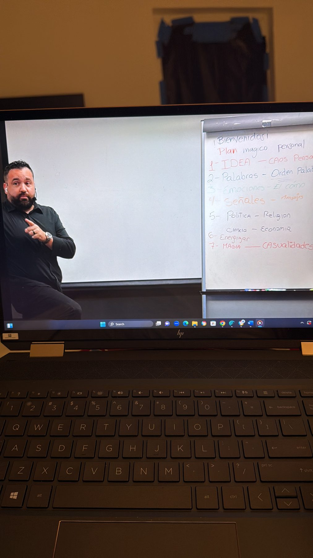 Carlos Leras teaching in front of a whiteboard with the Personal Magic Plan outline